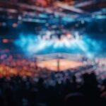 Blurred view of a boxing ring surrounded by a cheering crowd