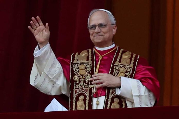 Religious leader in ceremonial attire waving from a balcony