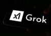 A smartphone screen displaying the Grok logo in white against a dark background