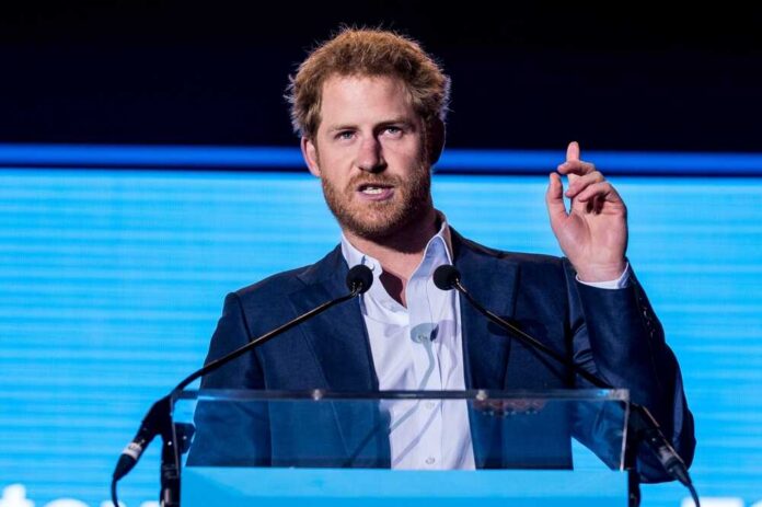 A man in a suit speaking at a podium during a conference