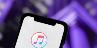 Close-up of a smartphone displaying the iTunes app logo