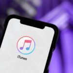 Close-up of a smartphone displaying the iTunes app logo