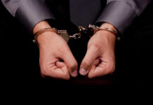 Hands in handcuffs, symbolizing arrest or detention