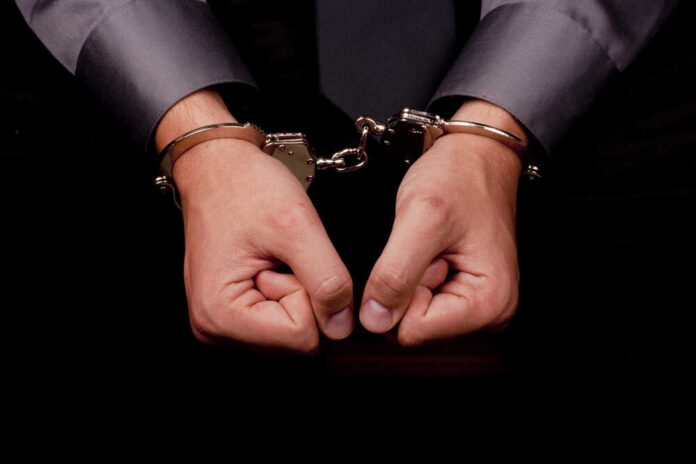 shutterstock_81665719.jpg Hands in handcuffs, symbolizing arrest or detention