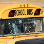 Damaged windshield on yellow school bus number 32