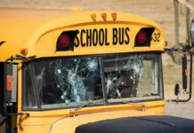 Damaged windshield on yellow school bus number 32