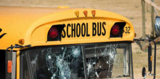 Damaged windshield on yellow school bus number 32