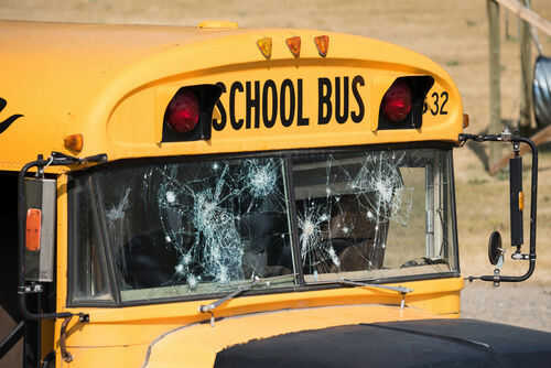Damaged windshield on yellow school bus number 32