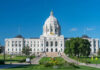Historic white capitol building under clear blue sky