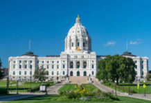 Historic white capitol building under clear blue sky