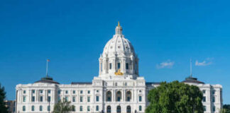 Historic white capitol building under clear blue sky