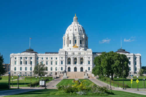 Historic white capitol building under clear blue sky