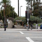 Intersection near MacArthur Park with traffic lights and palm trees