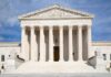 Front view of the Supreme Court building with large columns and sculptures