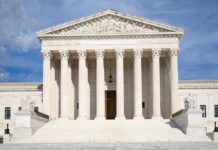 Front view of the Supreme Court building with large columns and sculptures