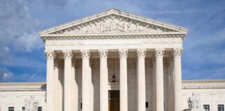Front view of the Supreme Court building with large columns and sculptures