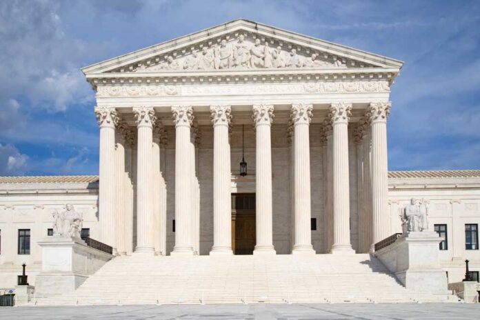 Front view of the Supreme Court building with large columns and sculptures