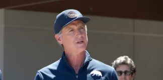 A government official speaking at a press conference outdoors