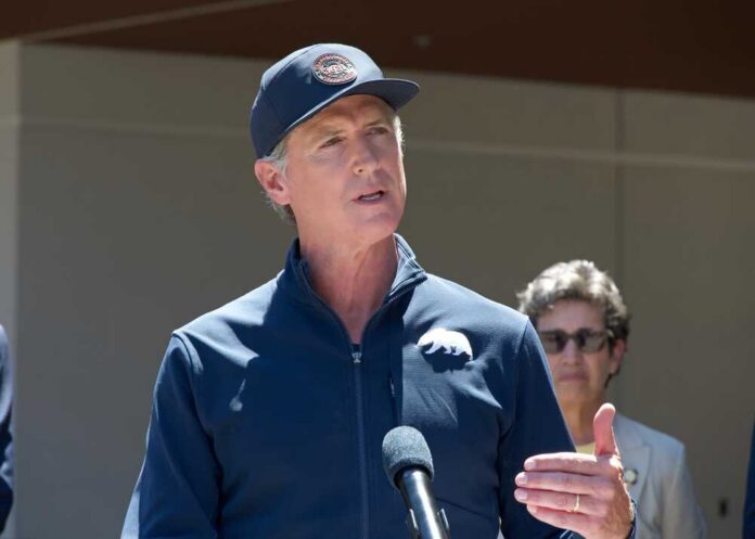 A government official speaking at a press conference outdoors