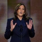 A female politician delivering a speech at a podium