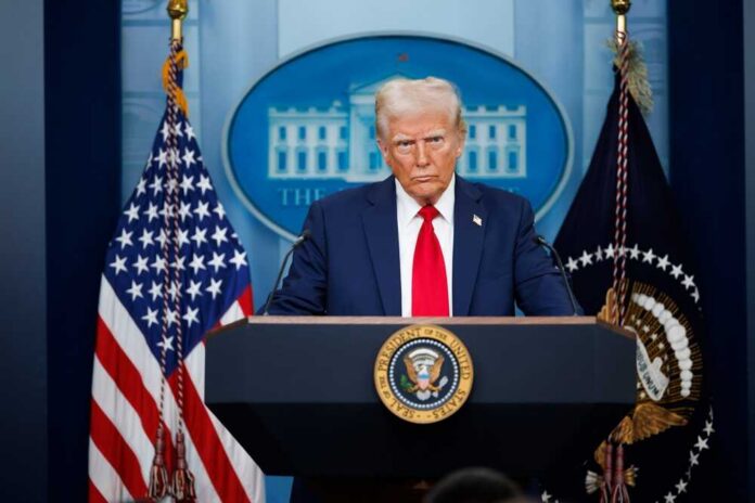 A political figure at a podium during a press conference