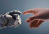 A robotic hand reaching out to touch a human hand