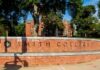 Sign for Smith College in front of a brick building surrounded by trees