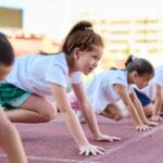 Children preparing to race on a track