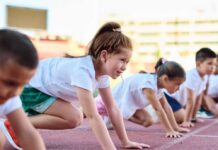 Children preparing to race on a track