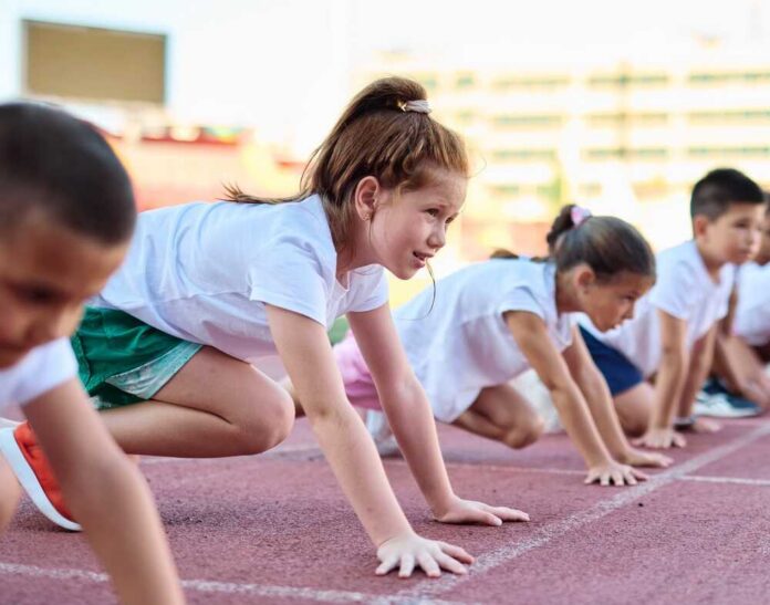 Children preparing to race on a track