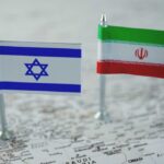 Mini flags of Israel and Iran on map