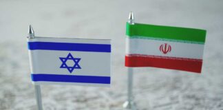 Mini flags of Israel and Iran on map