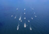 Aerial view of multiple naval ships operating in the ocean