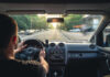 Seven-Year-Old Ejected — Hunt For Phantom Driver Driver holding steering wheel on a city street at sunset