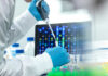 California Triggers Alert—No Sick People Scientist with pipette in front of DNA sequences