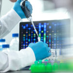 Scientist with pipette in front of DNA sequences