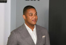 Man in a gray suit smiling at an event
