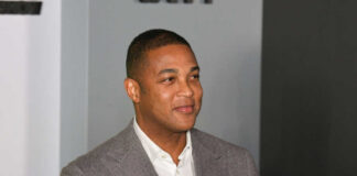 Man in a gray suit smiling at an event
