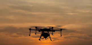 A drone flying against a sunset background