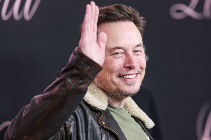 elon-musk700389456 Man in leather jacket smiling and waving