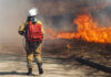 Europe’s Fire Emergency Reveals Something Bigger Firefighter approaches brush fire with backpack hose