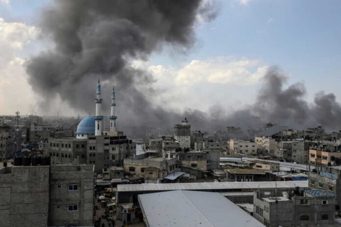 Cityscape with smoke rising, buildings, and a mosque.