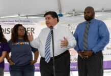 Three people speaking at a promotional event.