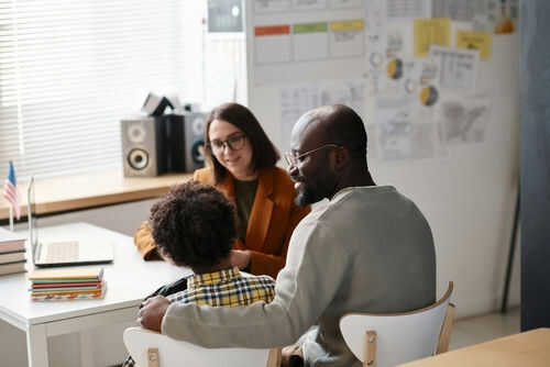 parent-in-school-pta2354102363 Three people sitting at a desk talking together