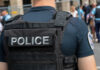 Police officer wearing tactical vest in crowd