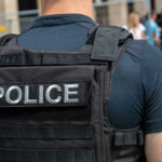 Police officer wearing tactical vest in crowd