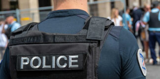 Police officer wearing tactical vest in crowd