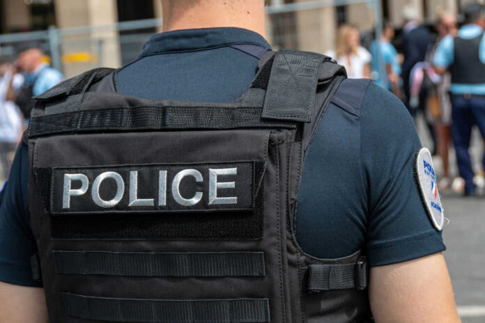 Police officer wearing tactical vest in crowd