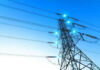Spain-Style Grid Meltdown Haunts Texas Electricity pylon with blue sky background