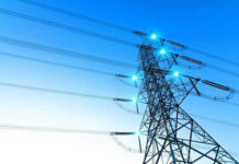 Spain-Style Grid Meltdown Haunts Texas Electricity pylon with blue sky background